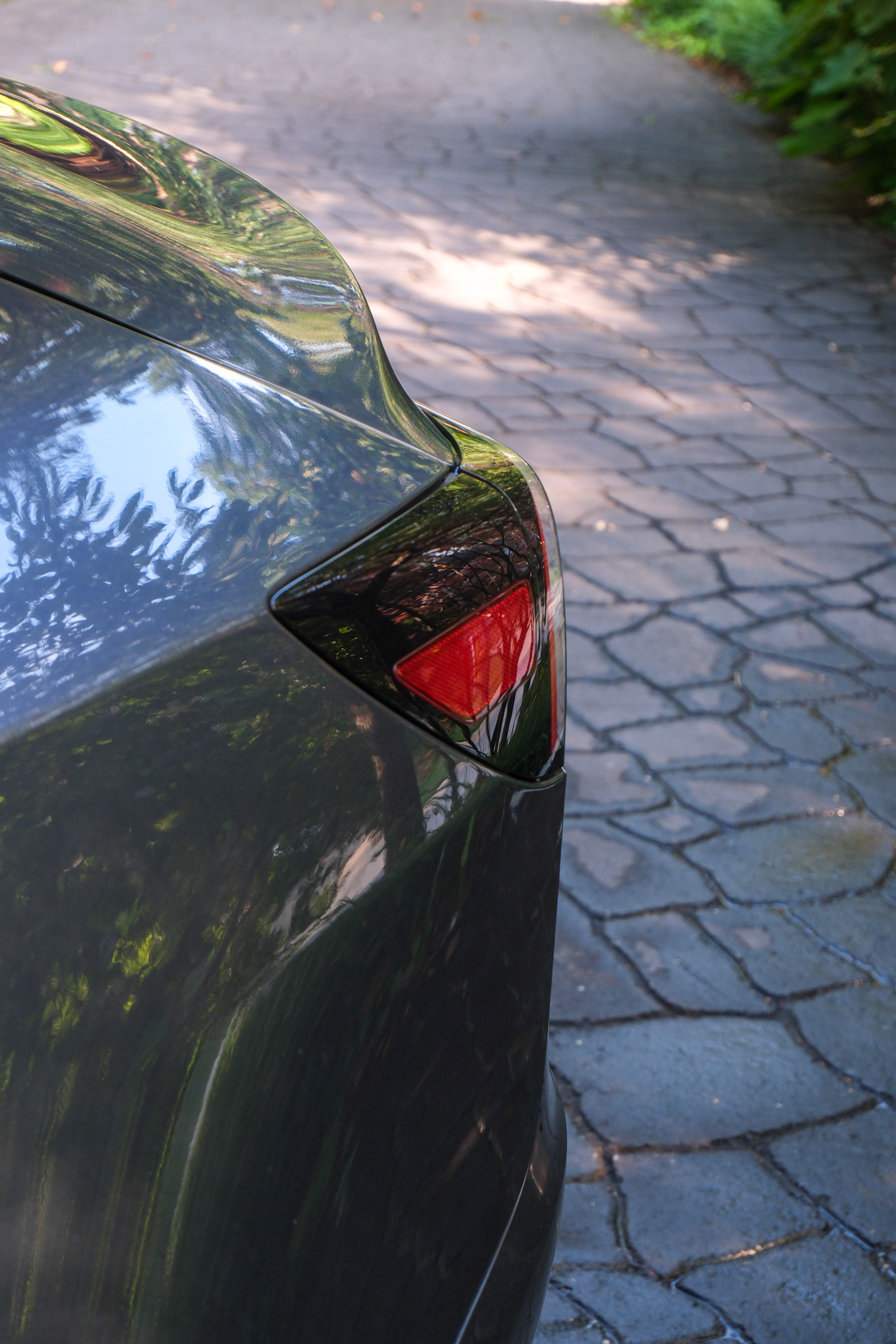 Tesla Model 3 rear quarter — mirror-finish paint after detailing